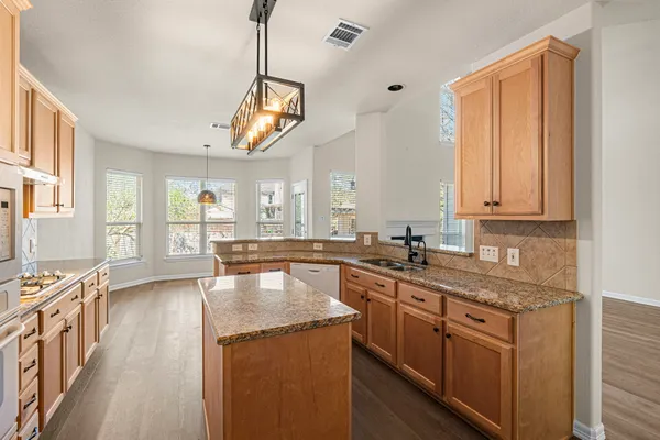 a view of a livingroom with wooden floor and a ceiling fan