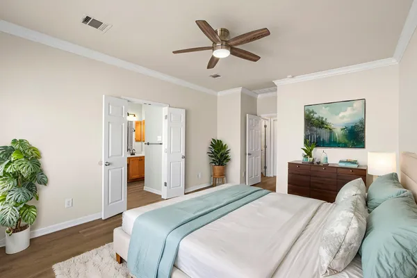 a view of a room with a ceiling fan and hardwood floor