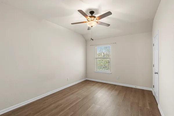 an aerial view of a house with a yard and parking