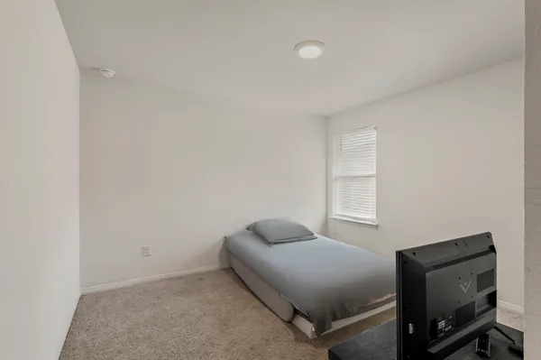 a bedroom with a bed and a tv