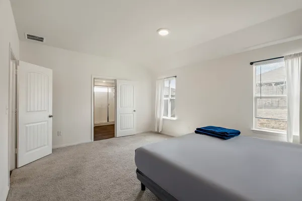 a bedroom with a bed and a window