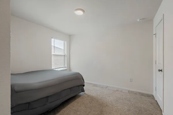 a room with a bed and a window