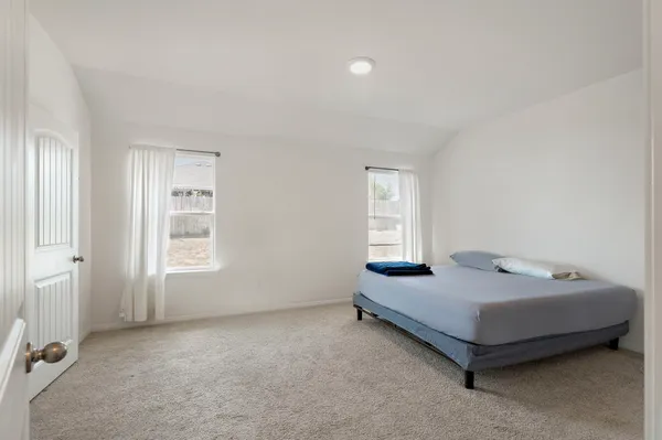 a bedroom with a bed and a window