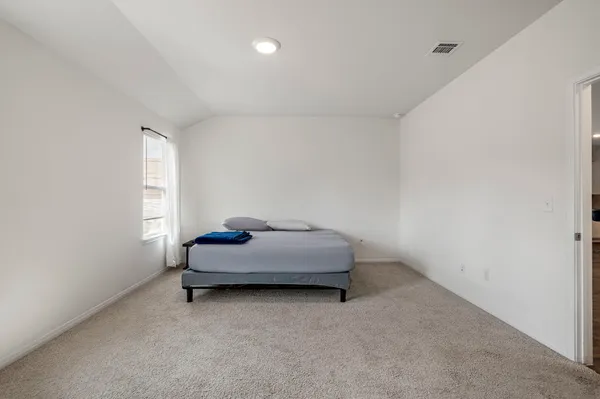 a room with a bed and window