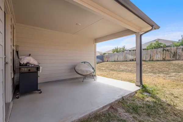 a view of a room with a floor to ceiling window and an outdoor space