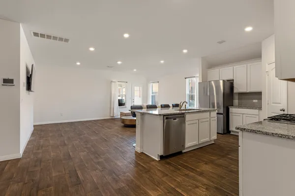 a kitchen with a refrigerator and a sink