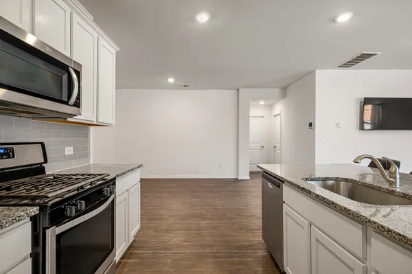 a kitchen that has a sink and a stove