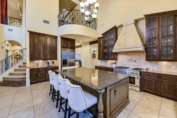 a kitchen with a table chairs sink and cabinets