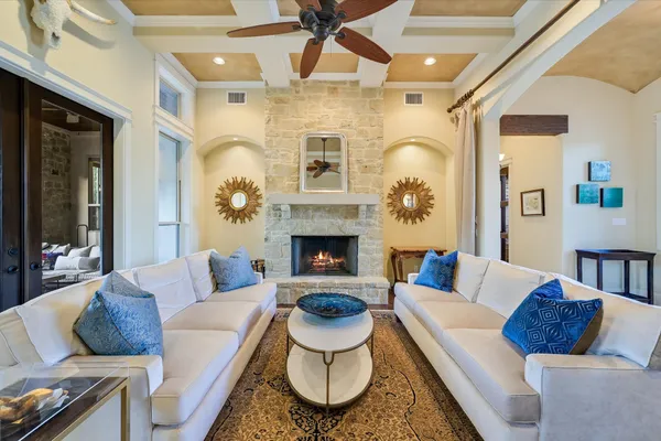 a living room with fireplace furniture and a window