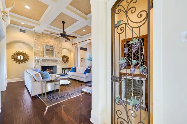 a living room with furniture a fireplace and a floor to ceiling window