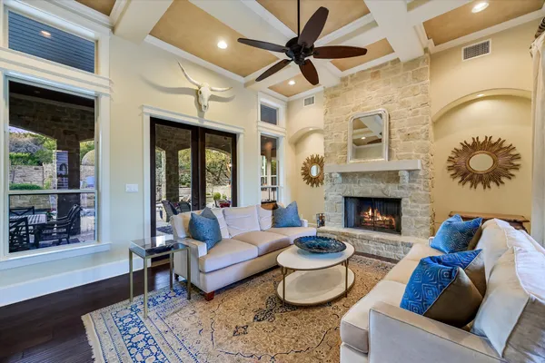 a living room with furniture a flat screen tv and a large window