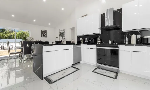 a kitchen with a sink a stove and cabinets