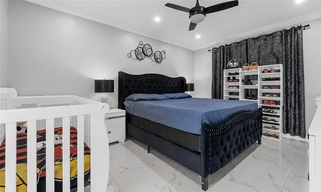 a bedroom with a large bed and a chandelier