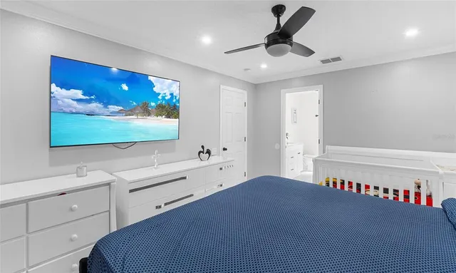 a bedroom with a bed and a flat screen tv