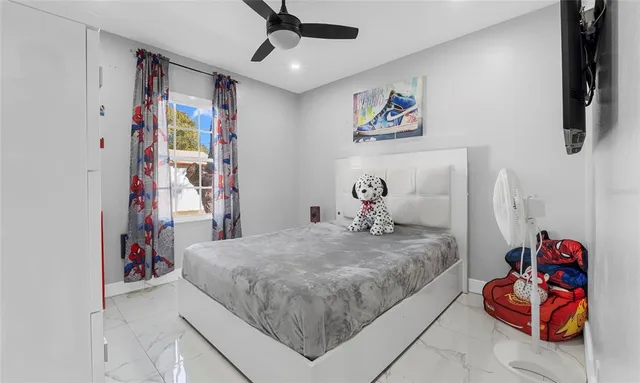 a bedroom with a bed and a painting on the wall