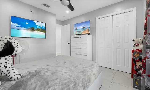 a bedroom with a bed and a painting on the wall