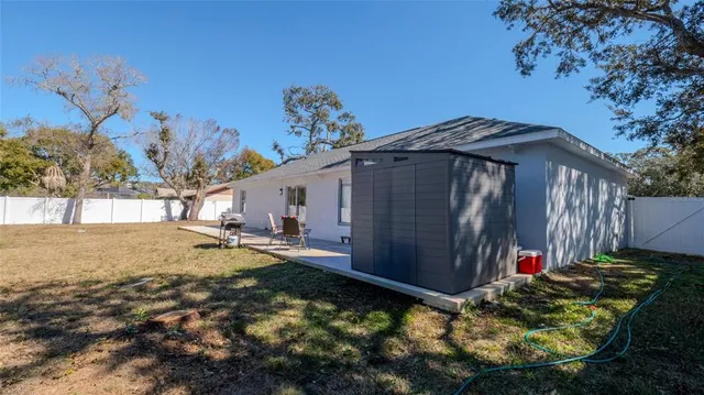 a view of a backyard with a table and chairs