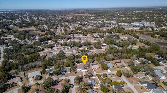 an aerial view of a house with a yard and garden