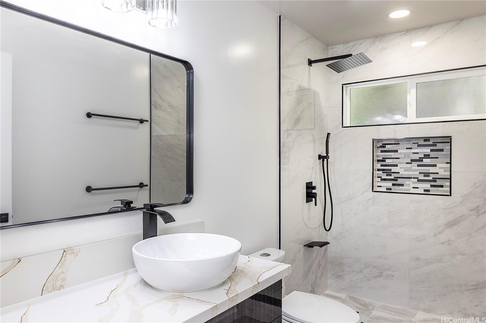 839 Oneawa Street Kailua, HI 96734 - Photo 11 of 14 a bathroom with a toilet sink and shower