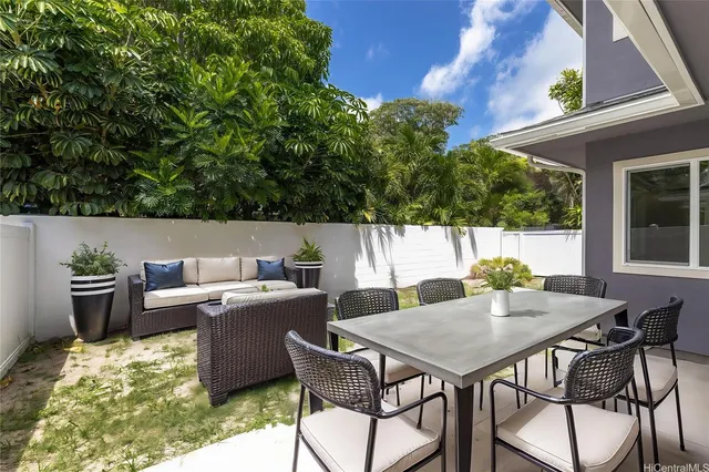 a view of a patio with table and chairs