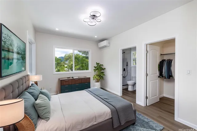 a bedroom with a large bed and a window