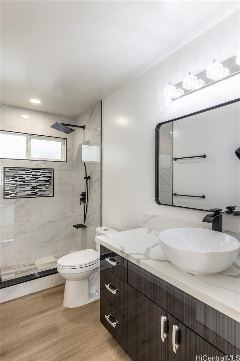 839 Oneawa Street Kailua, HI 96734 - Photo 8 of 14 a bathroom with a sink toilet a mirror and vanity