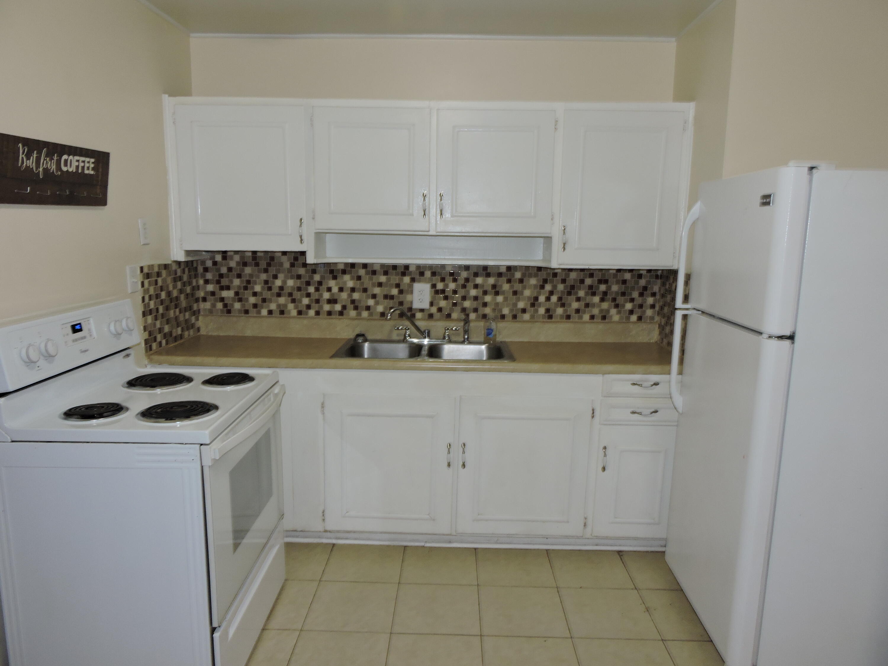 120 Sikes Drive Crestview, FL 32539 - Photo 5 of 18 a kitchen with white cabinets and white appliances