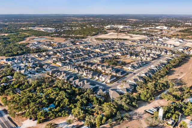 an aerial view of residential building and ocean