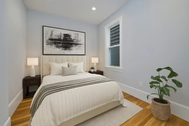 a bedroom with a bed and a painting on the wall