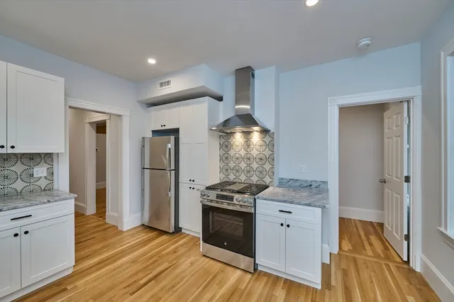 a kitchen with granite countertop a stove and a refrigerator