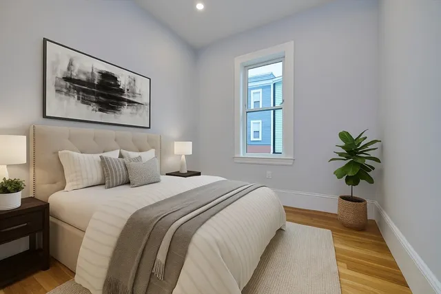 a bedroom with bed and a potted plant