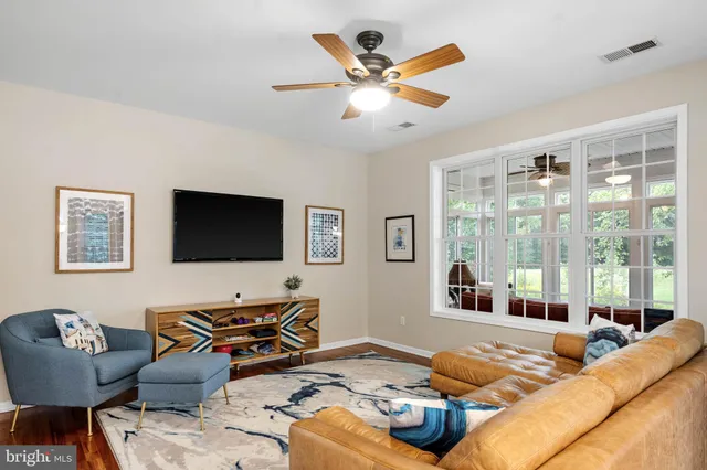 a bedroom with furniture and a flat screen tv
