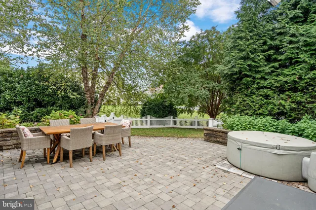 a view of a patio with table and chairs and potted plants