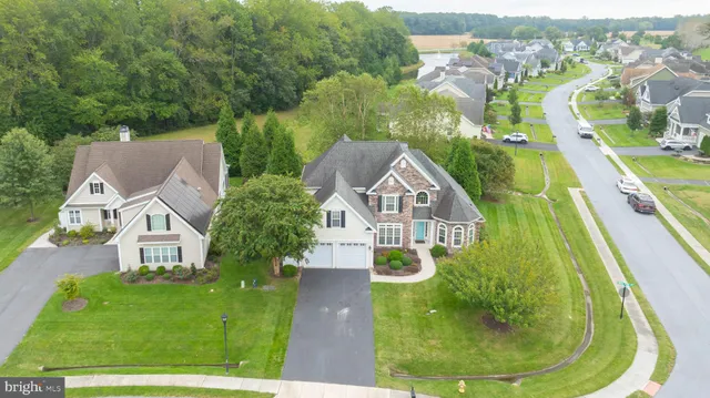 an aerial view of residential houses with outdoor space and swimming pool