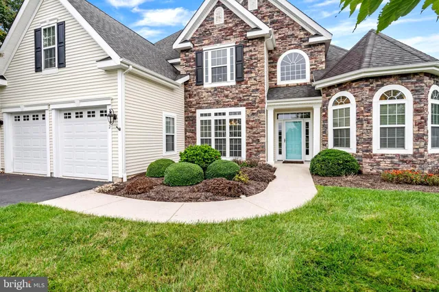 a view of a white house with a yard and plants