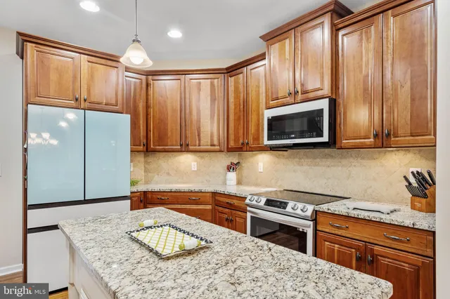 a kitchen with a sink a stove and cabinets