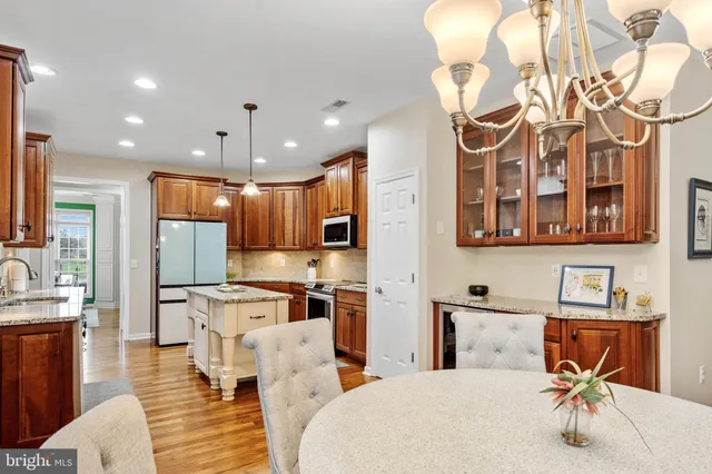 a large kitchen with a table and chairs
