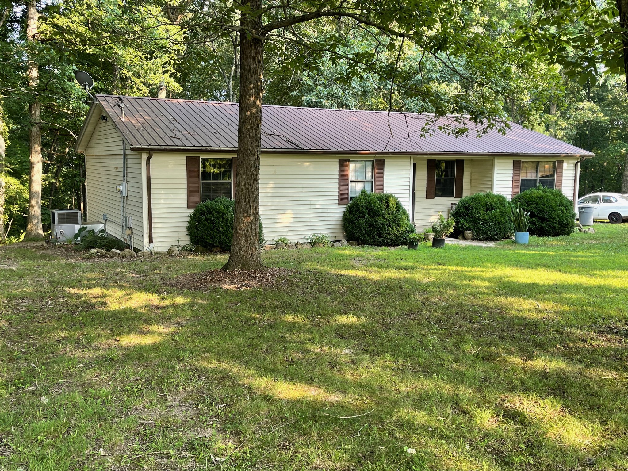 370 Buck Perry Road Bethpage, TN 37022 - Photo 1 of 2 a front view of a house with yard and green space