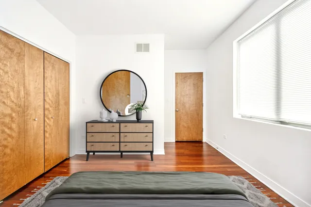 a living room with wooden floor and furniture