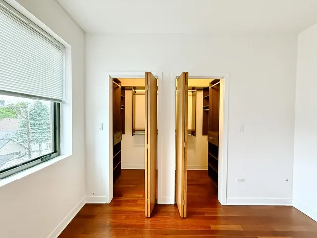a view of hallway with wooden floor