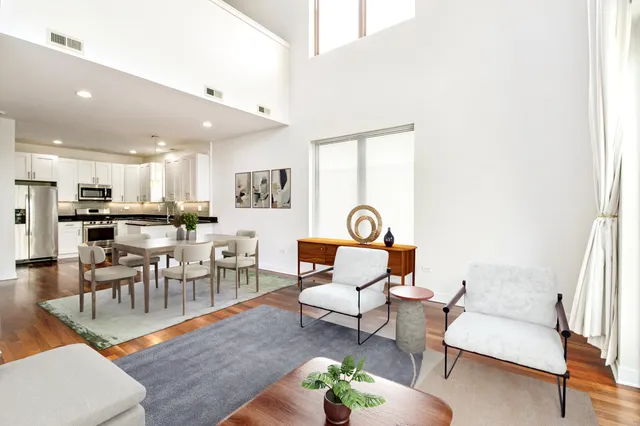 a living room with furniture and a dining table with kitchen view