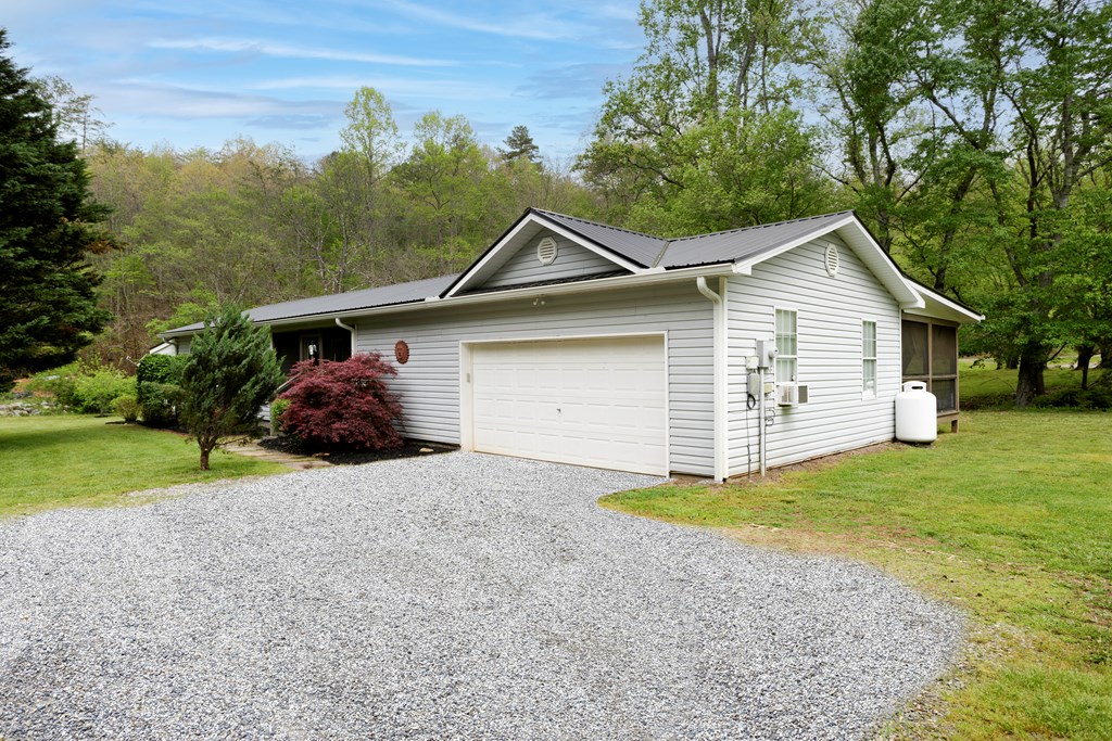 6491 Crooked Creek Road Young Harris, GA 30582 - Photo 12 of 59 a front view of a house with a yard and garage