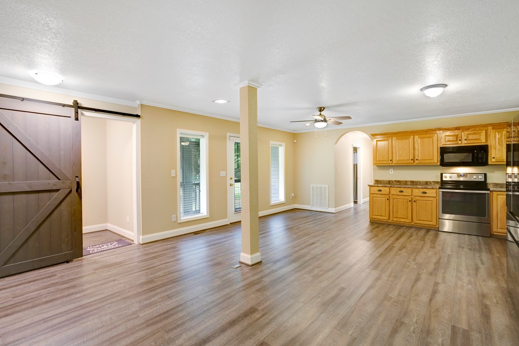 6491 Crooked Creek Road Young Harris, GA 30582 - Photo 16 of 59 a view of a kitchen with a stove wooden cabinets and a refrigerator