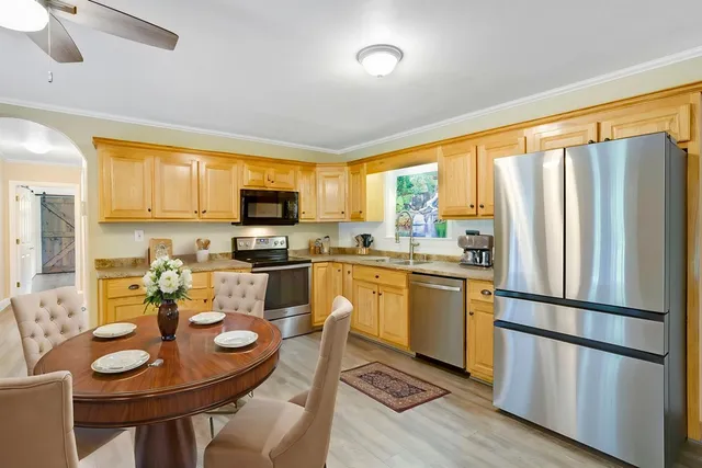 a view of an entryway with wooden floor and a ceiling fan