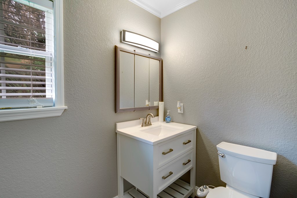 6491 Crooked Creek Road Young Harris, GA 30582 - Photo 29 of 59 a bathroom with a toilet sink and mirror