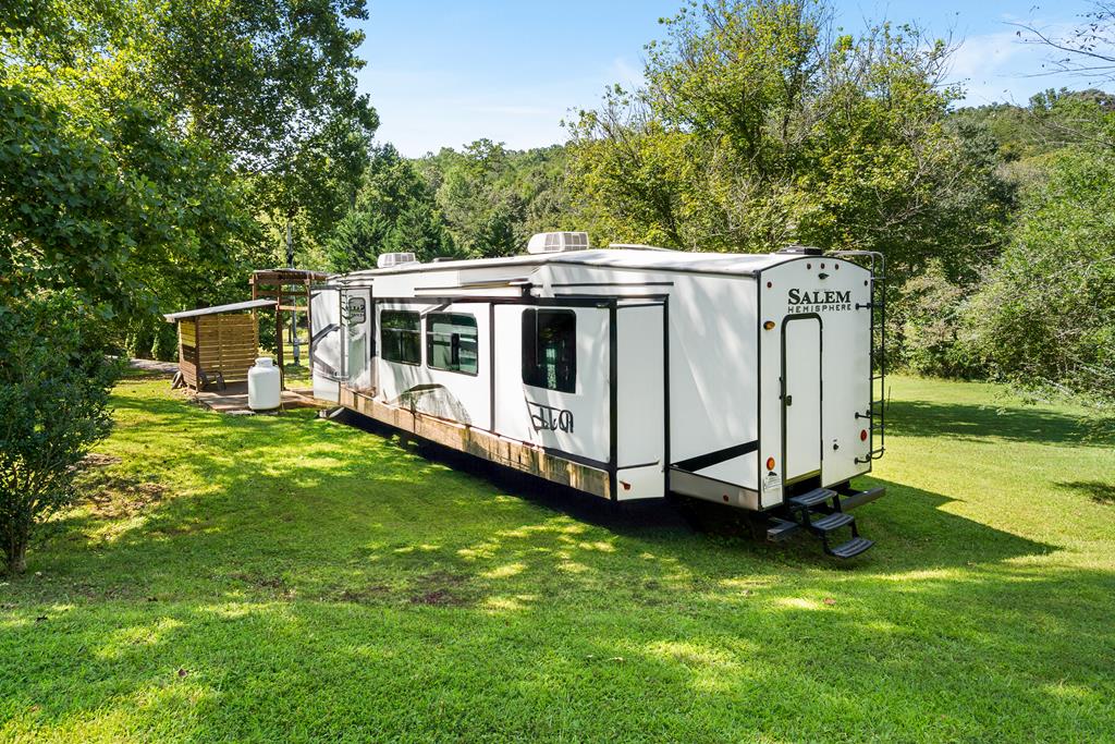 6491 Crooked Creek Road Young Harris, GA 30582 - Photo 51 of 59 a view of a house with backyard sitting area and garden