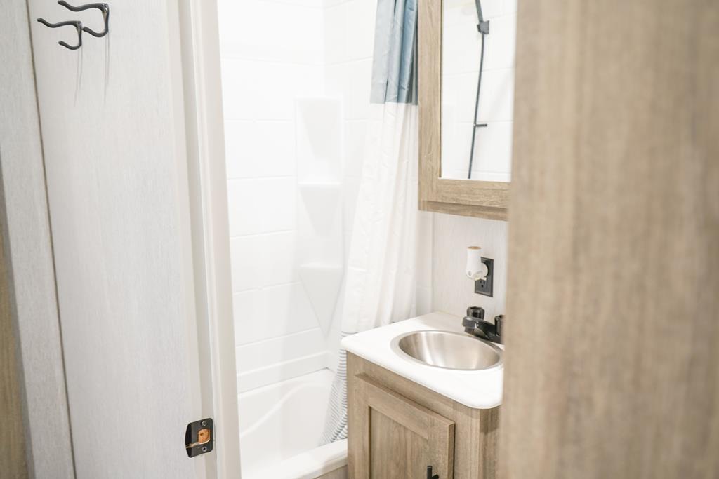 6491 Crooked Creek Road Young Harris, GA 30582 - Photo 58 of 59 a bathroom with a sink and a mirror