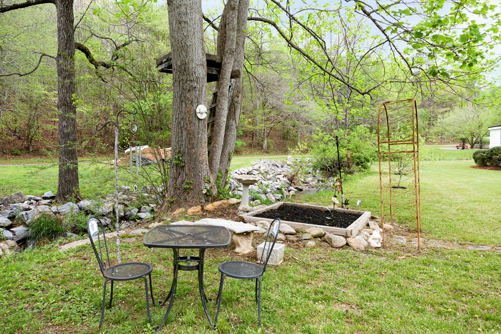 6491 Crooked Creek Road Young Harris, GA 30582 - Photo 9 of 59 a backyard of a house with table and chairs