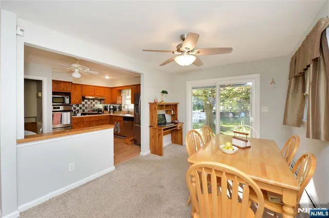 a large kitchen with a table and chairs