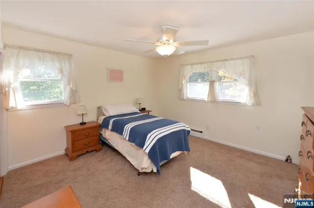 a spacious bedroom with a bed and a chandelier